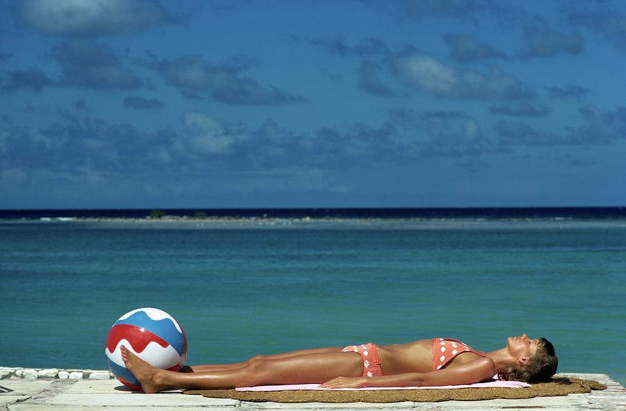 Model Lying on the Beach in a Polka Dot Bikini Photograph by Mike Reinhardt