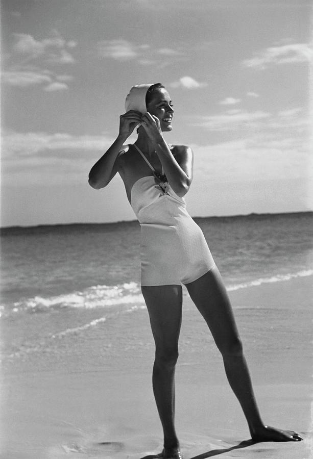 Model on a Beach Fastening Her Bathing Cap Photograph by Toni Frissell