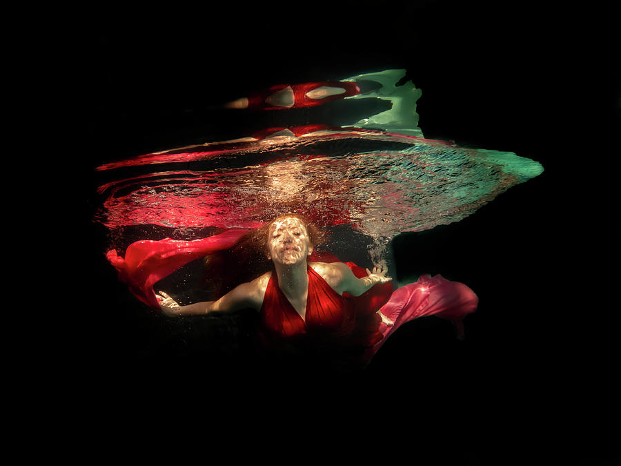 Model underwater in pool of light Photograph by Dan Friend