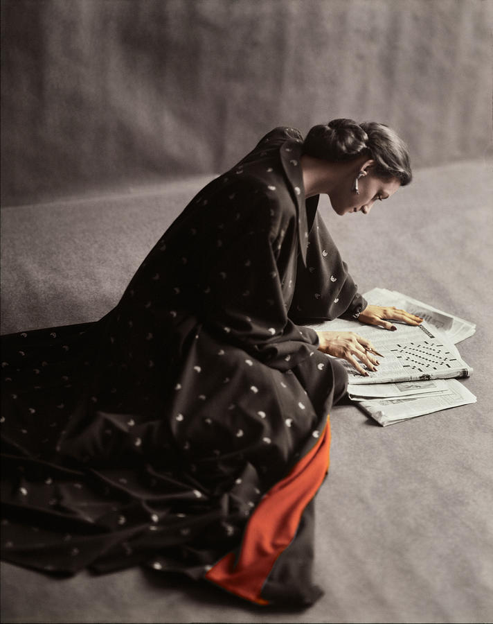 Model Doing A Newspaper Crossword Puzzle Photograph by Richard Rutledge