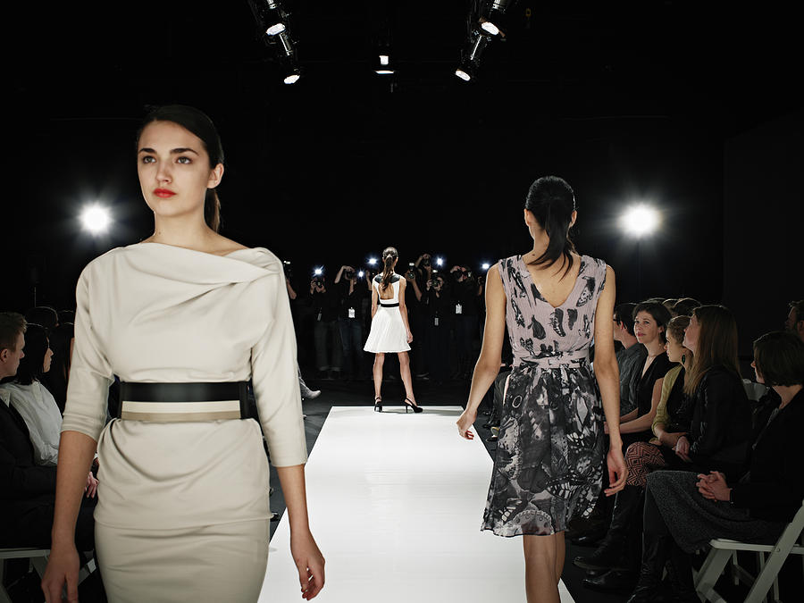 Models walking on runway during fashion show Photograph by Thomas Barwick