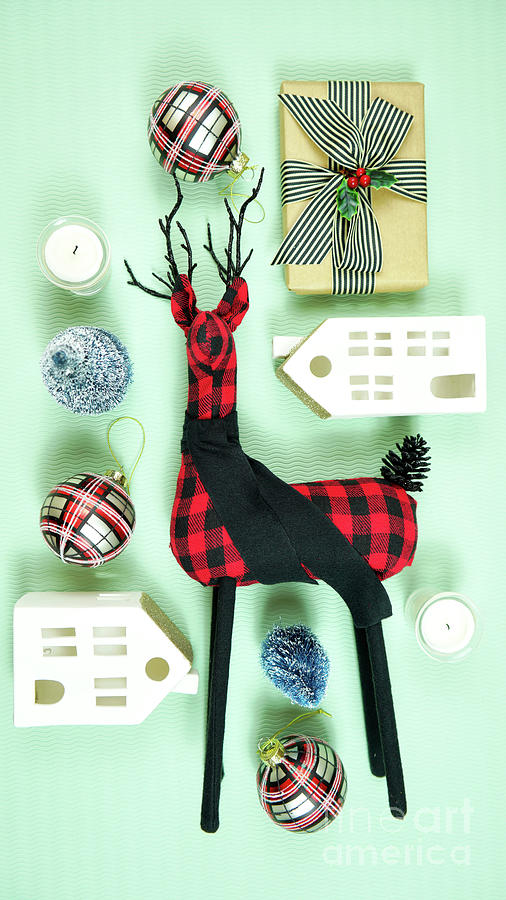 Modern Christmas gifts with buffalo plaid reindeer and decorations. Photograph by Milleflore Images