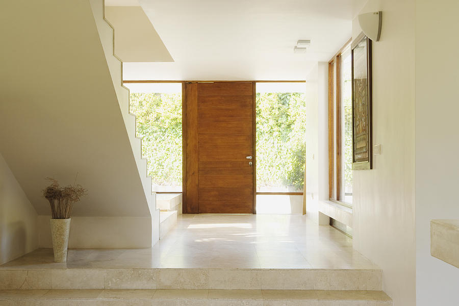 Modern hallway with wooden door Photograph by Martin Barraud