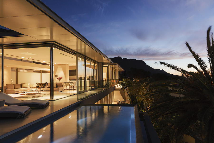 Modern house overlooking mountains at dusk Photograph by Astronaut Images