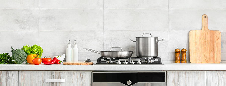 Modern kitchen countertop with domestic culinary utensils on it, home healthy cooking concept banner Photograph by Fortyforks