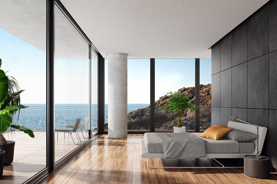 Modern luxurious bedroom in a seaside villa with black stone wall Photograph by Tulcarion