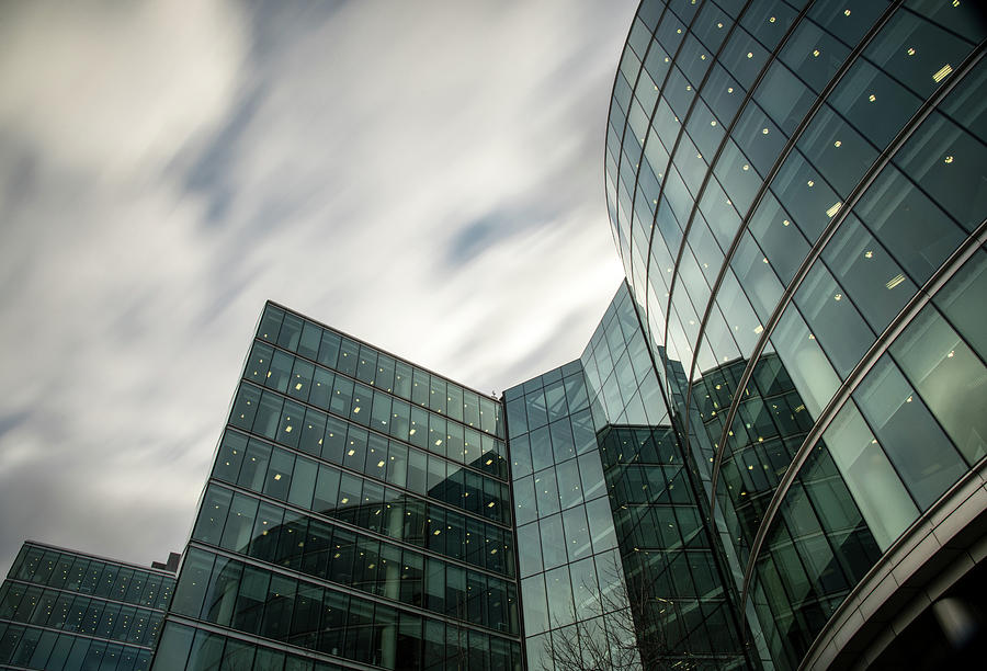 Modern office building details against sky. Long exposure photography, moving clouds Photograph by Michalakis Ppalis