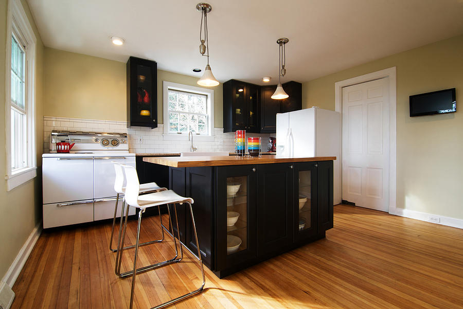 Modern residential kitchen with dark cabinets Photograph by Melissa Ross