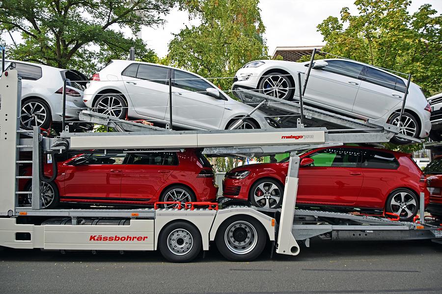 Modern Volkswagen Golf vehicles on the car transporter Photograph by Tramino