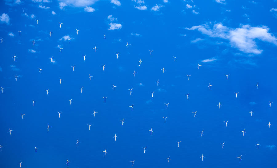 Modern windmills in an offshore wind farm in Northern Europe Photograph by Smartshots International