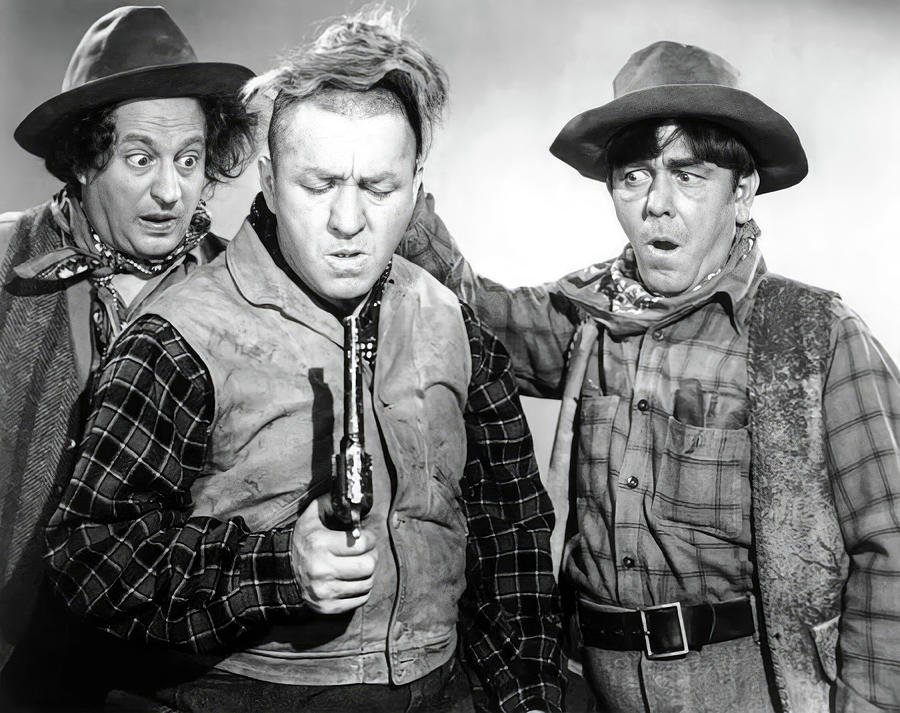 MOE HOWARD, LARRY FINE, CURLY HOWARD and THE THREE STOOGES in THE THREE TROUBLEDOERS -1946-. Photograph by Album