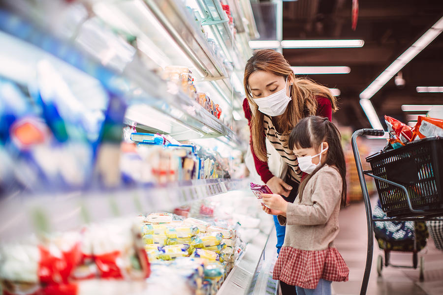 Mom & daughter with surgical masks doing grocery shopping for diary products in supermarket Photograph by Images By Tang Ming Tung