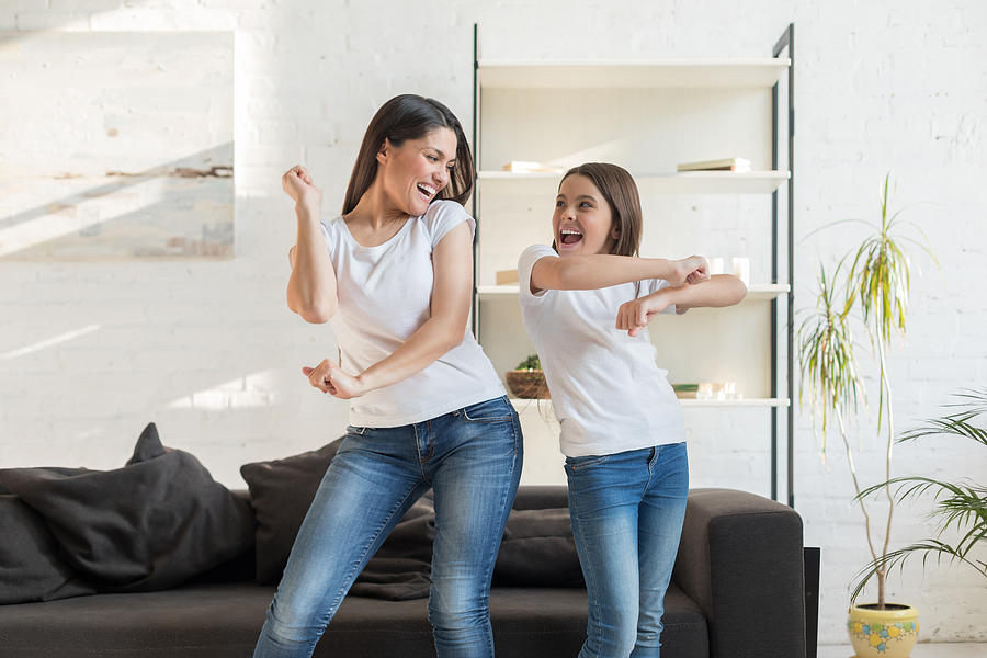 Mom with kid girl dancing in living room Photograph by Bymuratdeniz