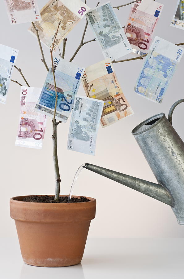 Money growing in a pot Photograph by Tetra Images