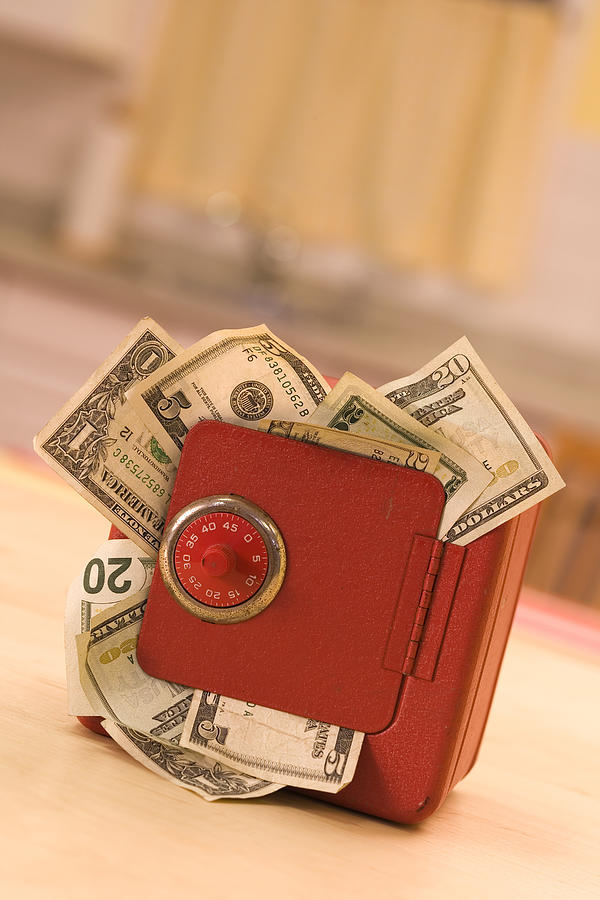 Money in a safe Photograph by Comstock Images