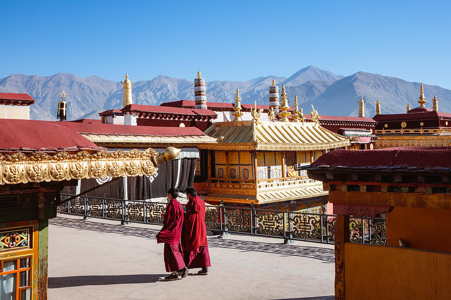 Monks inside Jokang temple, Lhasa, Tibet Photograph by Matteo Colombo