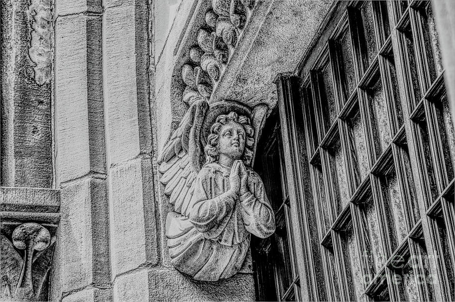 Monochrom of an Angel on the Church of the Holy Name of Jesus on Oxford Road, Manchester, England. Photograph by Pics By Tony