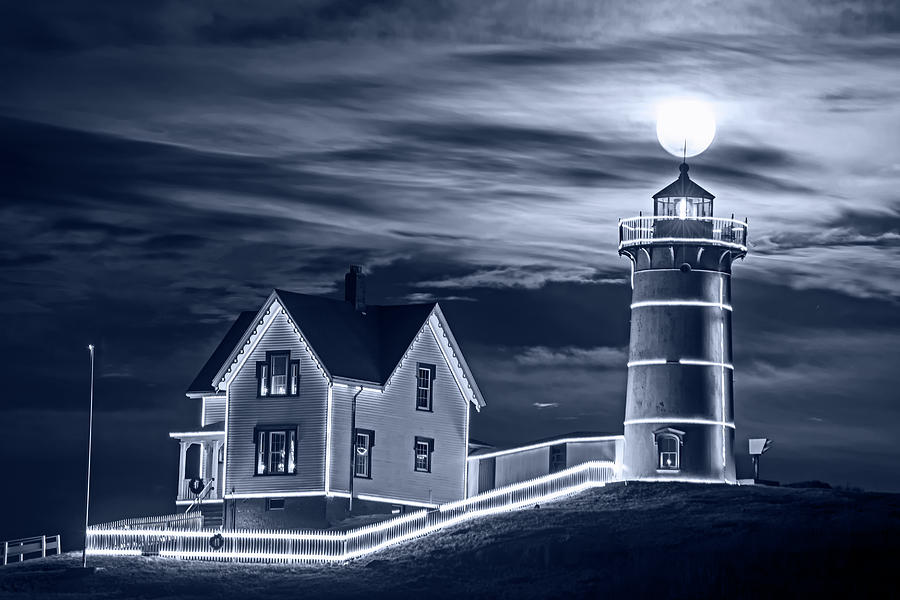 Monochrome Blue Nights The supermoon rising over the top of the Nubble Lighthouse York Maine Photograph by Toby McGuire