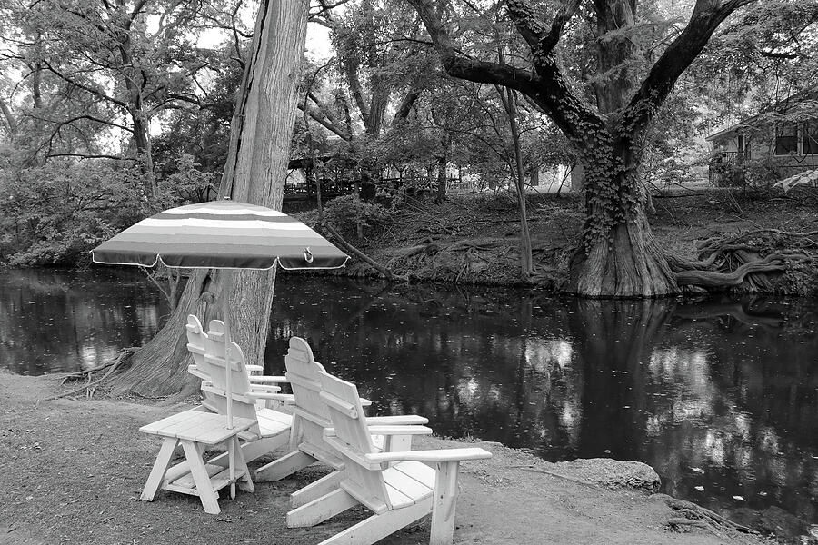 Monochrome View of Sun Umbrella and White Chairs by Blanco River Photograph by Brigitte Blanchette Thompson Monochrome View of Sun Umbrella and White Chairs by Blanco River Photograph by Brigitte Blanchette Thompson