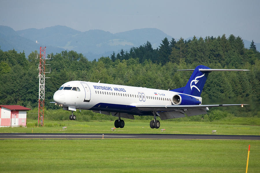 Montenegro airlines aircraft landing at Ljubljana Joze Pucnik Ai Photograph by Ian Middleton