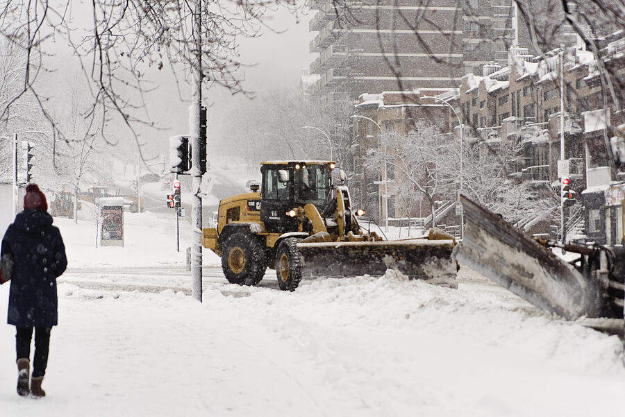 Montreal street with snowplow during snowstorm. Photograph by Martinedoucet