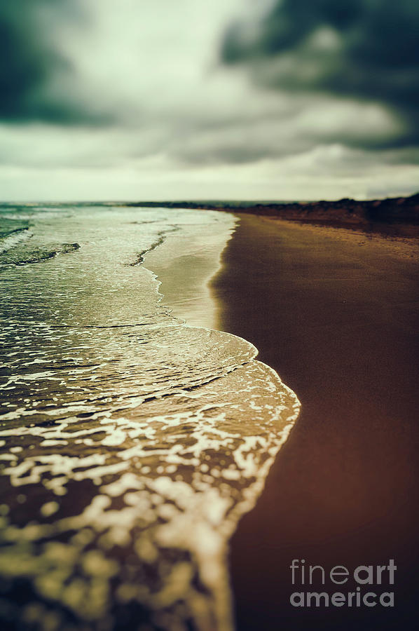 Moody beach with dramatic sky Photograph by Silvia Ganora