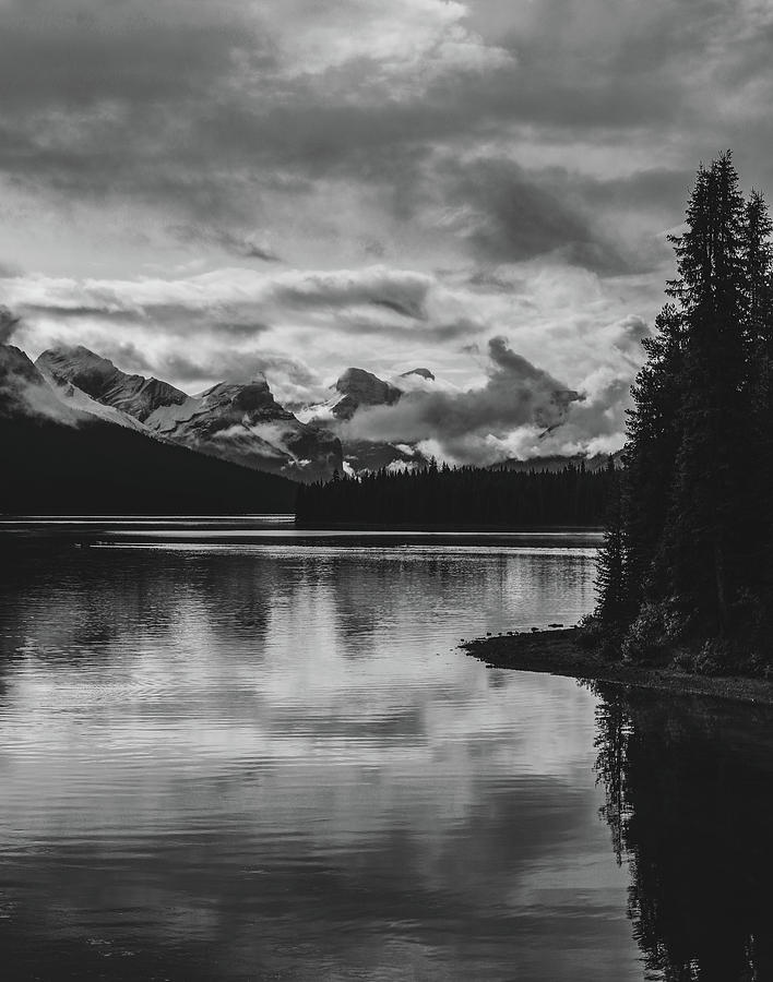 Moody Reflection On Maligne Lake Black And White Photograph by Dan Sproul