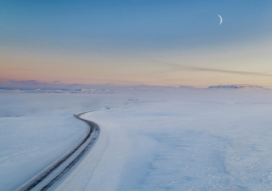 Moon and snowy mountain road, Iceland Photograph by Panoramic Images