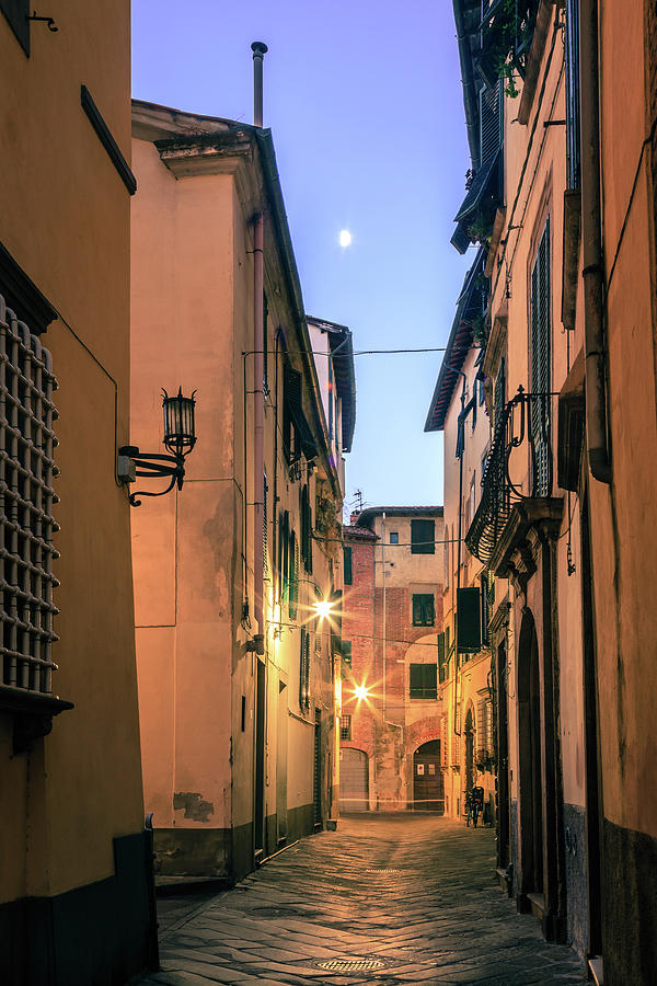 Moon over old Lucca Photograph by Alexey Stiop