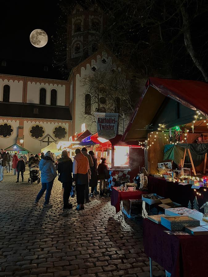 Moon over the Christmas Market Photograph by Richard Cummings