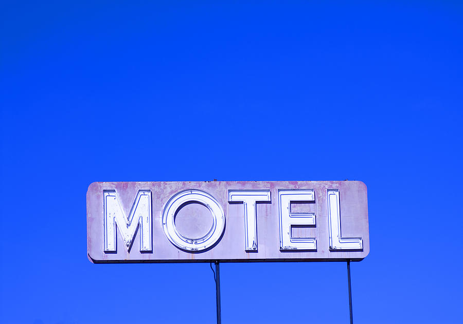 Motel sign against blue sky Photograph by Lyn Holly Coorg