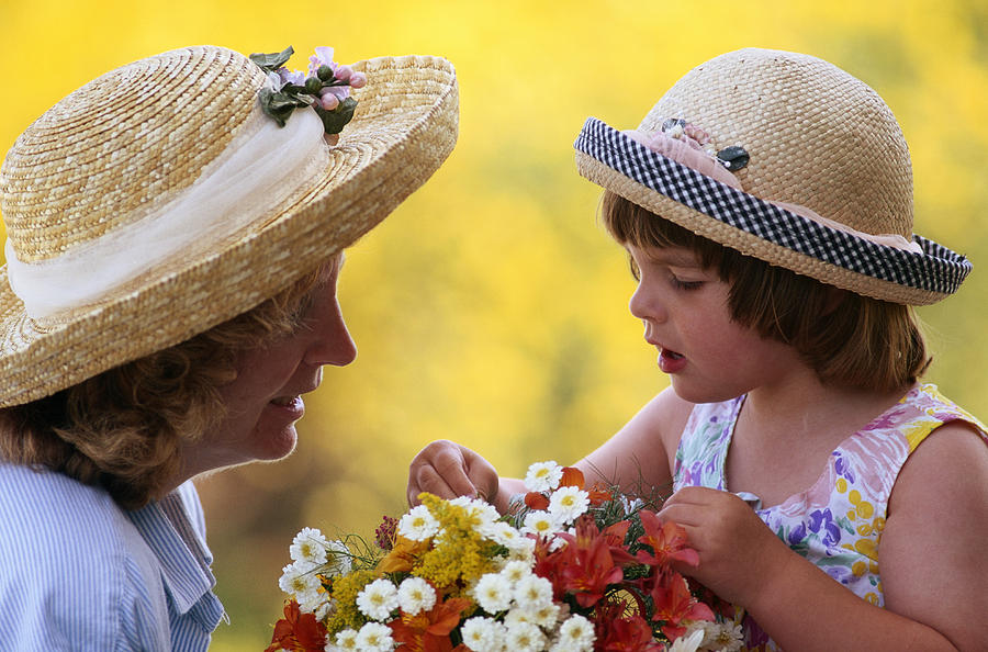 Mother & Young Girl In Hats With Flowers Photograph by Grant Faint