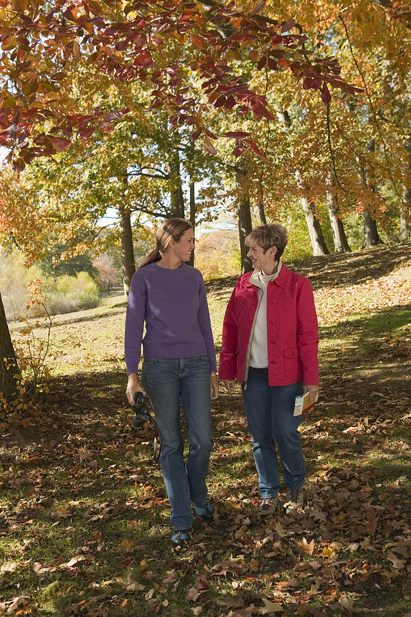 Mother and adult daughter walking outdoor Photograph by Comstock Images