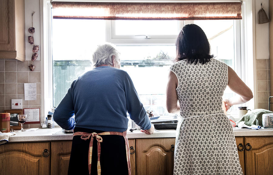 Mother and adult daughter washing dishes together Photograph by Gary John Norman
