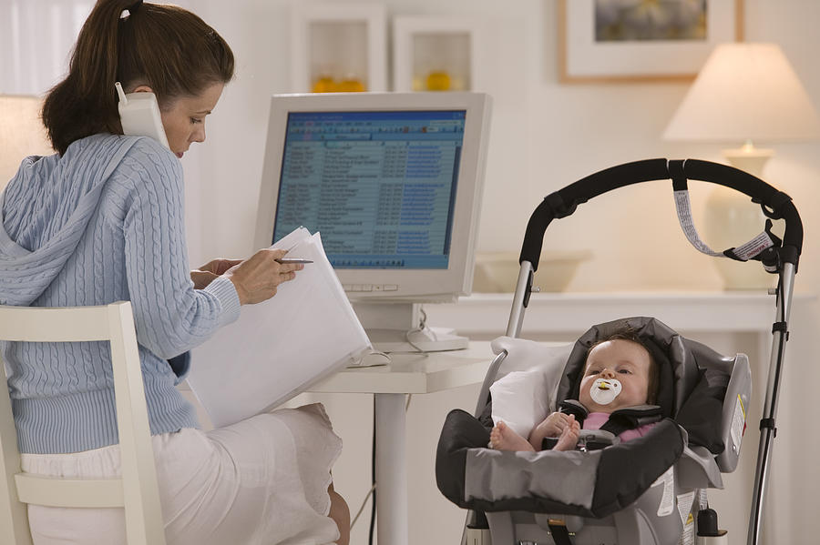Mother and baby in home office Photograph by Comstock Images