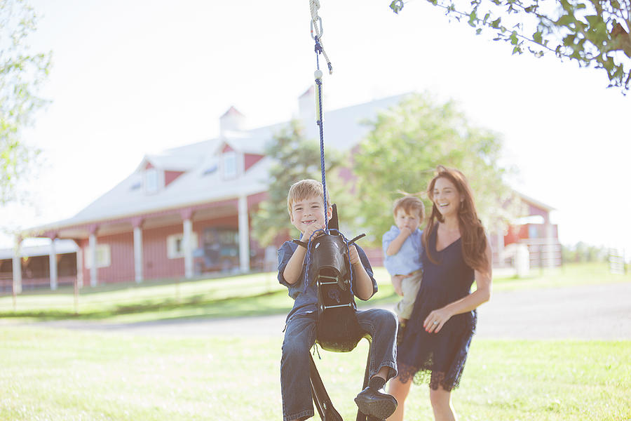 Mother and boys swinging on Rural Colorado Farm Photograph by Eyecrave Productions