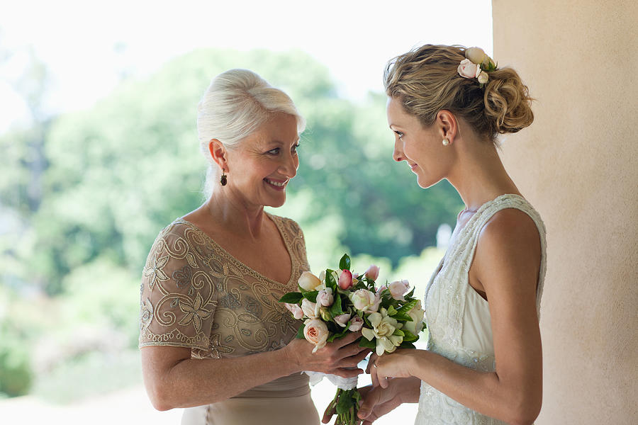 Mother and bride smelling bouquet Photograph by Tom Merton