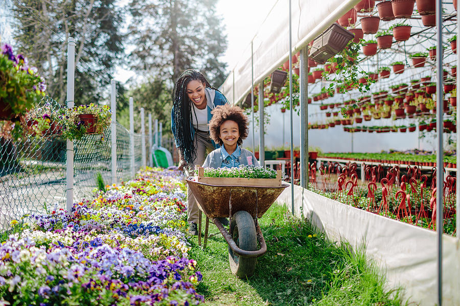 Mother And Daughter Gardening Photograph by Filmstudio