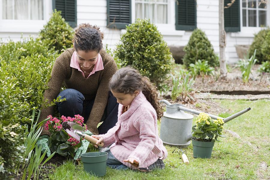 Mother and daughter gardening Photograph by Image Source