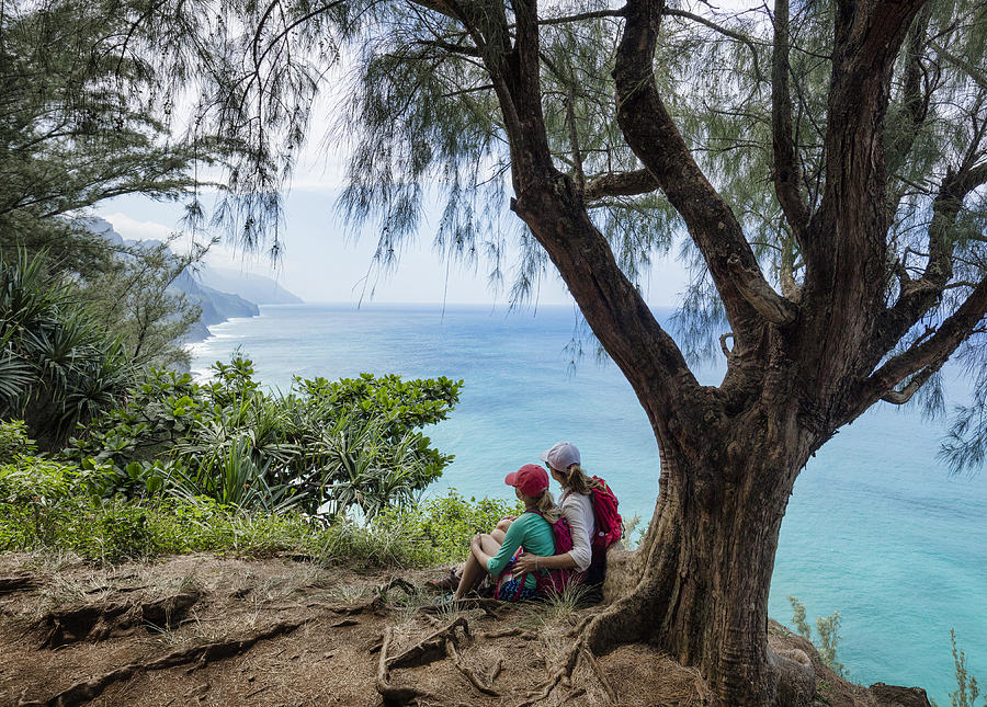 Mother and daughter hiking Na Pali Coast Photograph by Per Breiehagen
