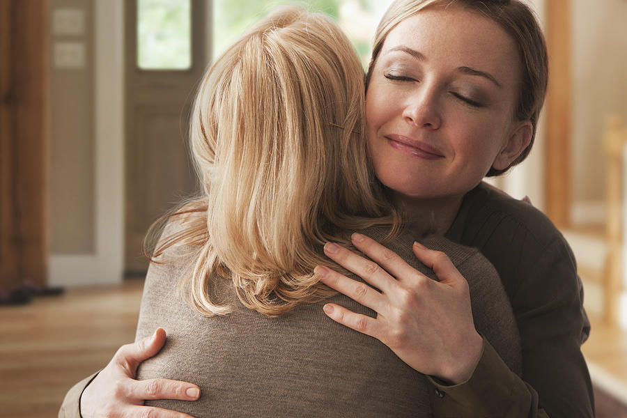 Mother and daughter hugging Photograph by SelectStock
