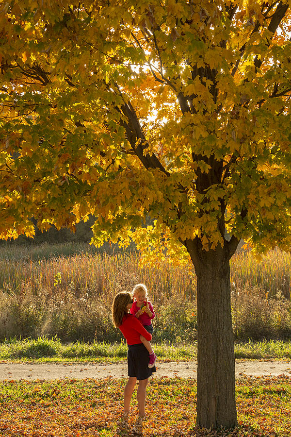 Mother and daughter  in fall leaves Photograph by Per Breiehagen