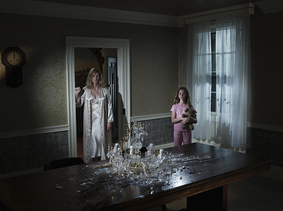 Mother And Daughter Looking At Broken Chandelier Photograph by Todd Warnock