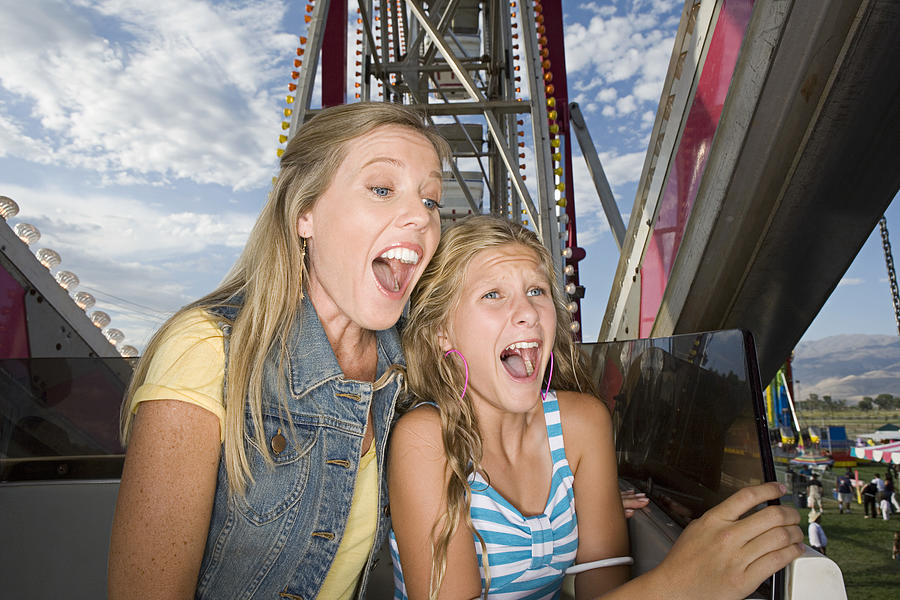 Mother and daughter screaming on ride Photograph by Jupiterimages