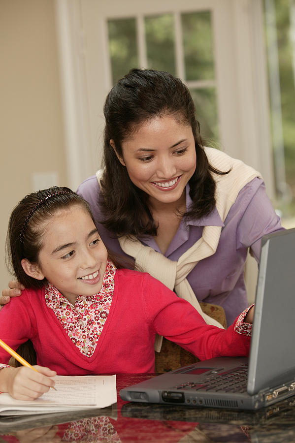 Mother and daughter using laptop Photograph by Comstock Images