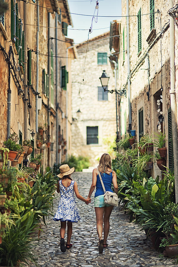 Mother and daughter visiting mediterranean town of Valldemossa Photograph by Imgorthand