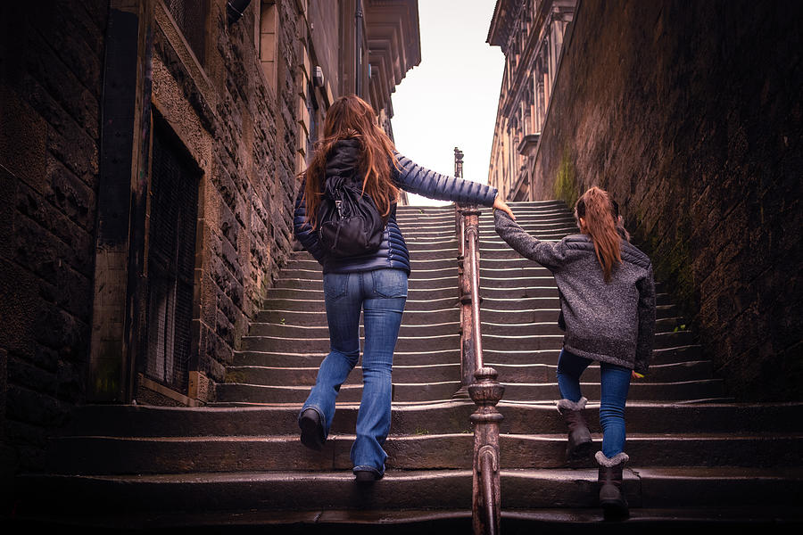 Mother and daughter walking up steps in Edinburgh, Scotland Photograph by Bradleyhebdon