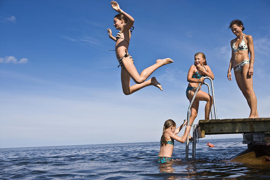 Mother and daughters swimming Oland Sweden. Photograph by Ulf Huett Nilsson