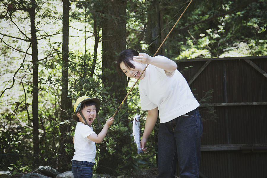 Mother and son fishing a trout in the mountain together Photograph by Kohei_hara