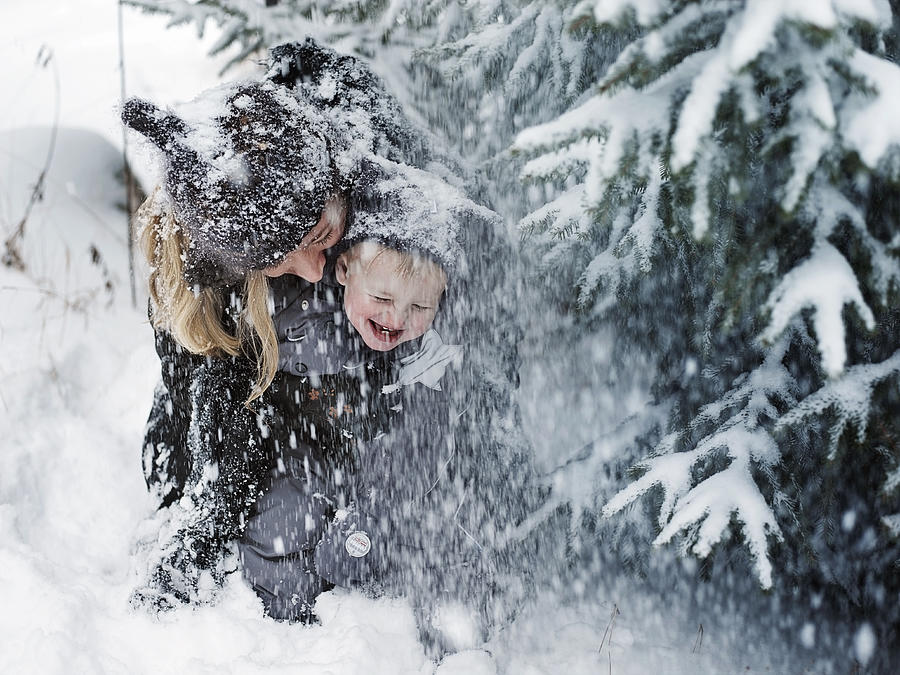 Mother and son in snowstorm Photograph by David Trood